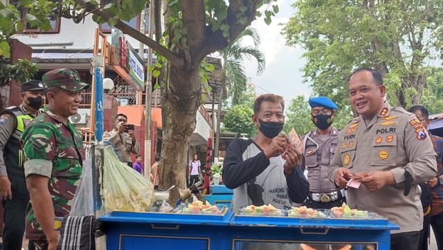 Kapolres Kediri Kota AKBP Wahyudi memborong sejumlah dagangan penjual kaki lima di Alun-Alun Kota Kediri (Nanang Priyo Basuki)